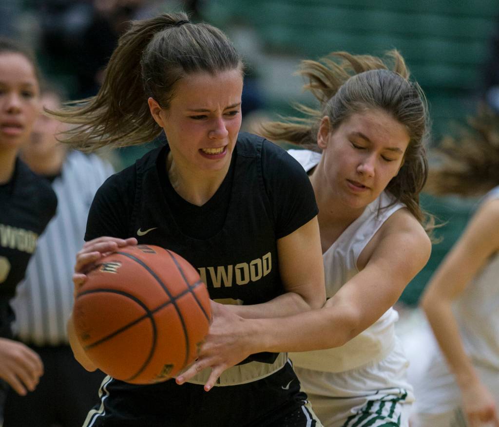 Lynnwoods Sara McArthur fights Jacksons Paige Swander for the ball during the game on Tuesday in Everett. (Olivia Vanni / The Herald)