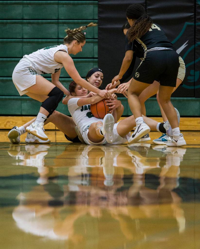 Jackson and Lynnwood players fight for the ball during the game on Tuesday in Everett. (Olivia Vanni / The Herald)