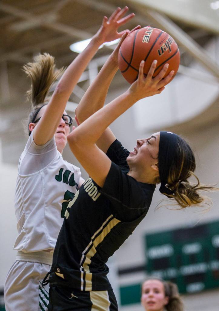 Lynnwoods Kayla Lorenz attempts a layup while Jacksons Hannah Mack tries to block her shot during the game on Tuesday in Everett. (Olivia Vanni / The Herald)