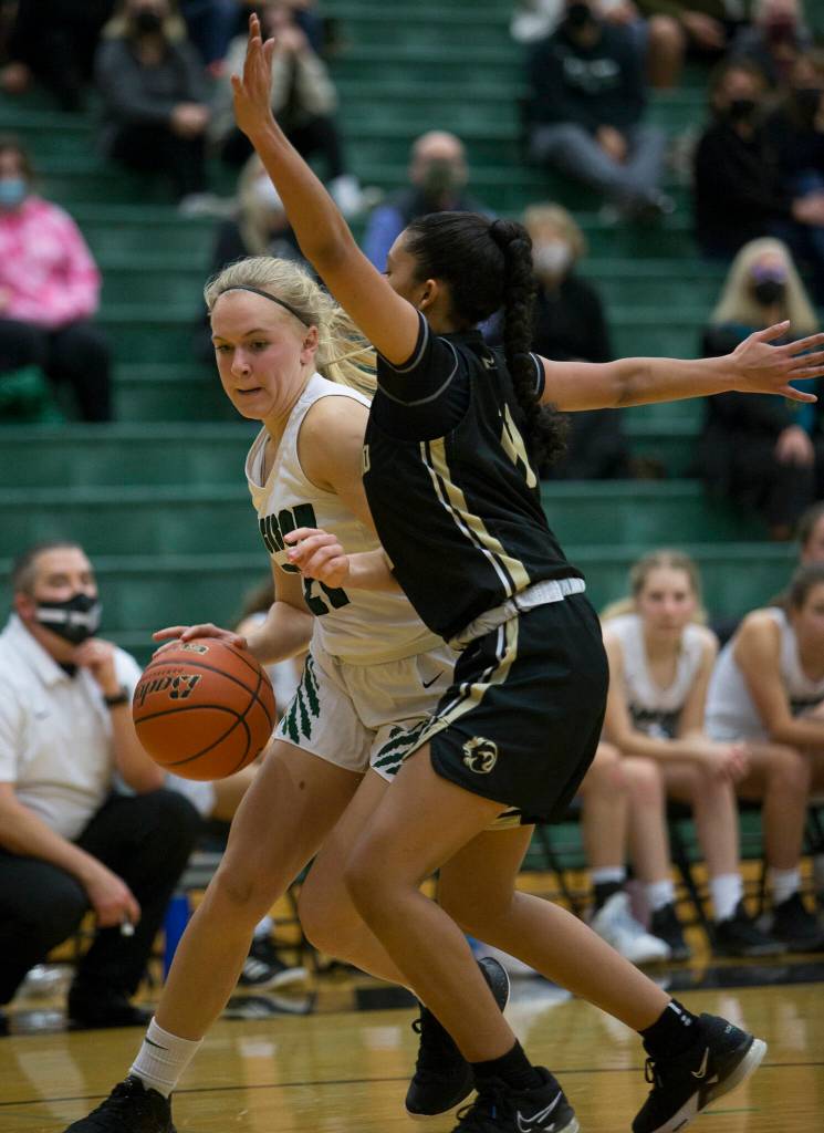 Jacksons Emma Merwin tries to dribble around Lynnwoods Mia Jones during the game on Tuesday in Everett. (Olivia Vanni / The Herald)