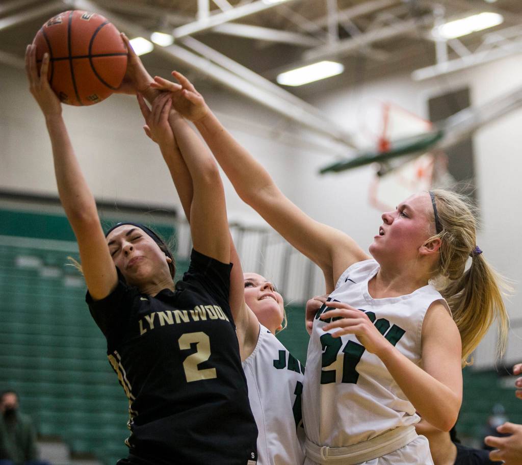 Jacksons Emma Merwin tries to take the ball from Lynnwoods Kayla Lorenz during the game on Tuesday in Everett. (Olivia Vanni / The Herald)