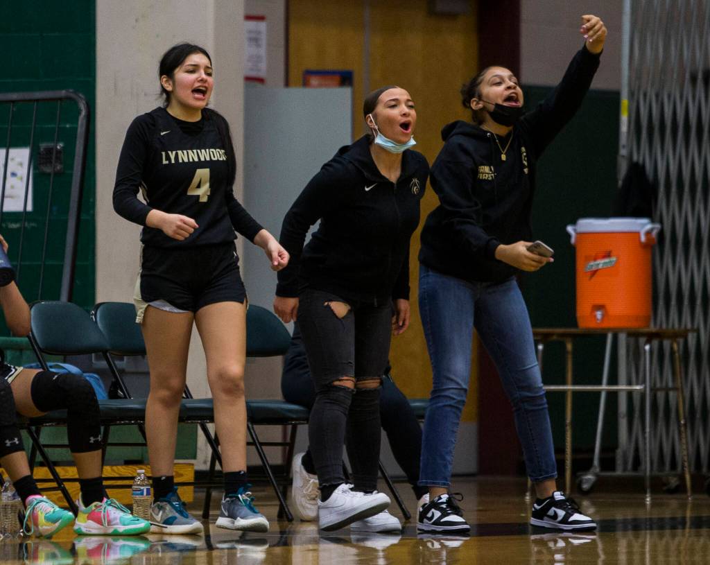 Lynnwood players react to their teammate making a three-point shot during the game against Jackson on Tuesday in Everett. (Olivia Vanni / The Herald)