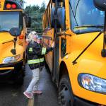 Kelly Brookbank, a former resident of Whispering Pines, performs a pre-drive check on a school bus in Seattle. (Kevin Clark / The Herald)