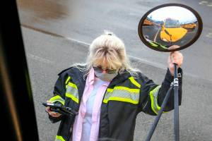Kelly Brookbank performs a pre-drive check on her bus Wednesday morning at the depot in Seattle on December 8, 2021. (Kevin Clark / The Herald)