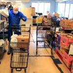 Mike Delaney gathers foods stuffs for clients at the Everett Food Bank on Dec. 1. (Kevin Clark / The Herald)