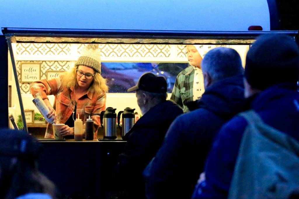 Tia Bulter (left) and Jakob Dishneau pour hot drinks Dec. 1 as part of Project Serve at First Presbyterian Church in Everett. (Kevin Clark / The Herald)