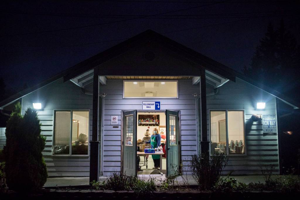 Volunteers open the doors Nov. 30 for Faith Lutheran Churchs food service night as part of the Everett Hot Meals Coalition. (Olivia Vanni / The Herald)