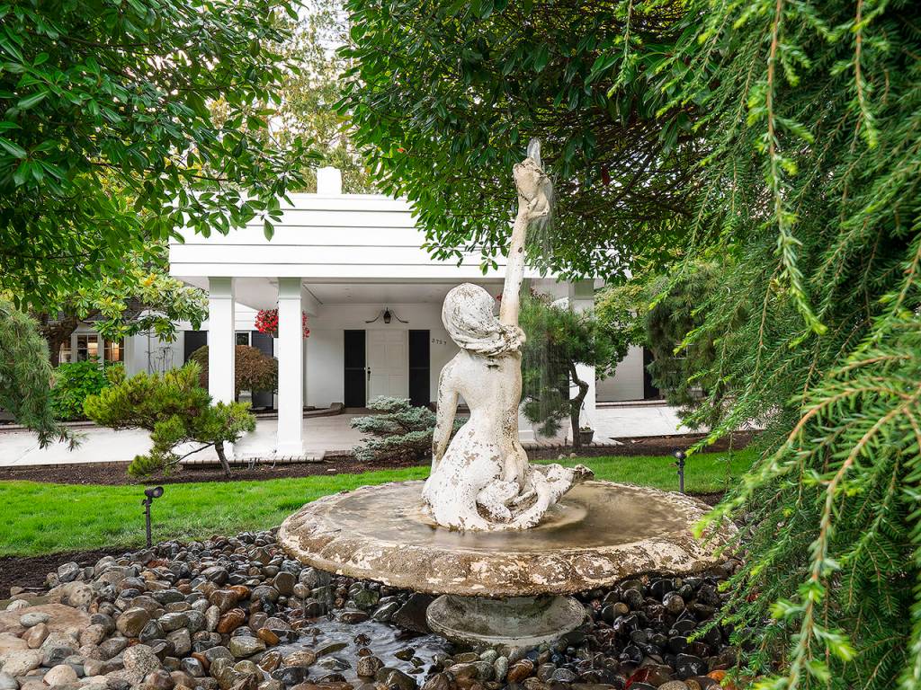 The fountain in front of the 10,000-square-foot home at 3727 Shore Ave. on the market for almost $5 million. (Norton Zanini)