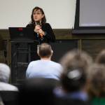 Amie Waters, the assistant director of the Early Learning Center, speaks to a crowd gathered at Everett Community College on Tuesday. (Olivia Vanni / The Herald)