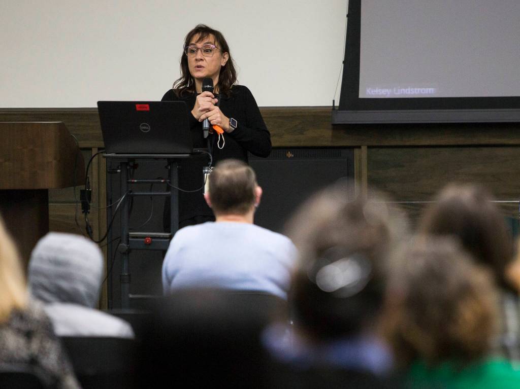 Amie Waters, the assistant director of the Early Learning Center, speaks to a crowd gathered at Everett Community College on Tuesday. (Olivia Vanni / The Herald)