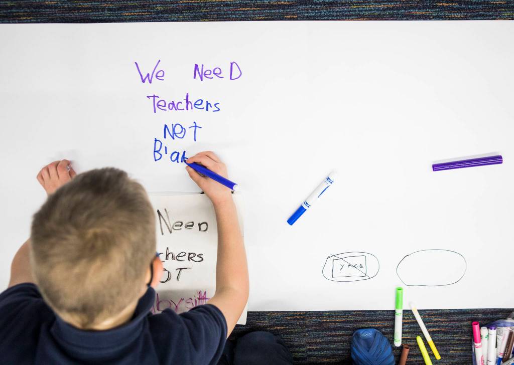 Kids write down their thoughts about the proposed closing of the Early Learning Center. (Olivia Vanni / The Herald)