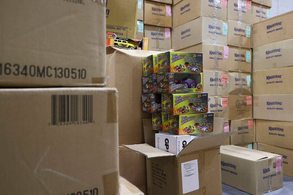 Toys are unboxed at the Everett Boys Girls Club Christmas House on Monday. (Andy Bronson / The Herald)