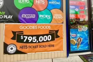 A banner outside the door of Goodies in Mountlake Terrace says, “$795,000 Hit 5 ticket sold here.” (Andrea Brown / The Herald) 20211201