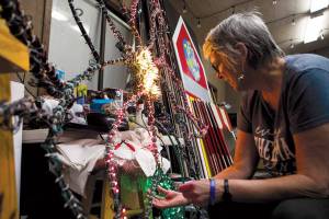 Carolyn Cross repairs light strands on a flower christmas light frame at Warm Beach Camp & Conference Center on Tuesday, Oct. 12, 2021 in Stanwood, Wa. (Olivia Vanni / The Herald)