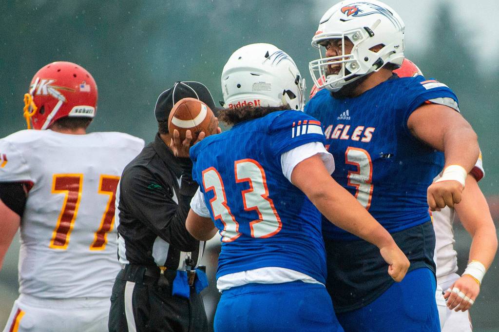 Graham Kapowsin offensive lineman Vega Ioane celebrates with running back Michael Toa (33) after Toa gained a first down in the third quarter of a State 4A semifinal game against Kamiakin on Saturday afternoon at Art Crate Field in Spanaway. (Photo provided by Tacoma News Tribune)