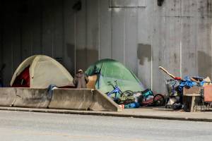 Previous Smith Ave campers have relocated to across the  'no-sit, no-lie' ordinance boundary and set up on Hewitt at the US 2 entrance in Everett. (Kevin Clark / The Herald)