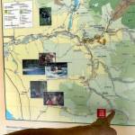 A traveler points to Bedal Campground on a map posted along the Mountain Loop Highway in June. (Sue Misao / Herald file)