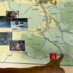 A traveler points to Bedal Campground on a map posted along the Mountain Loop Highway in June. (Sue Misao / Herald file)