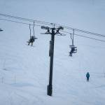 People ride the chair lift during last years Dec. 4 opening day at Stevens Pass. (Olivia Vanni / Herald file)