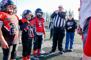Preston Dwoskin, referee, leads the coin toss before the start of the Buddy Bowl Saturday afternoon at Marysville Getchell High School in Marysville on December 11, 2021. (Kevin Clark / The Herald)