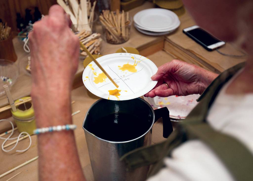 The chandler in Langley fine-tunes candle colors. (Olivia Vanni / The Herald)