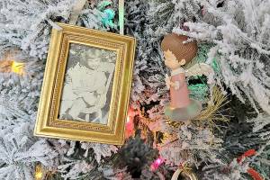 Caption: Family photos like this one of the author’s grandmother give extra meaning to this family’s holiday decorations.