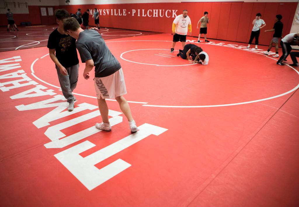 Coach Tony Hatch (standing, upper right) at wrestling practice at Marysville Pilchuck High School. (Olivia Vanni / The Herald)