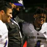 Lake Stevens Tom Tri, center, comforts his players Ansh Vinaya, left, and Trayce Hanks after the 4A State Championship game Saturday evening at Mt.Tahoma High School in Tacoma on December 4, 2021. The Viking lost 44-7. (Kevin Clark / The Herald)