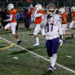 Lake Stevens star running back Jayden Limar walks off as Graham-Kapowsin players celebrate their programs first-ever state title. (Kevin Clark / The Herald)