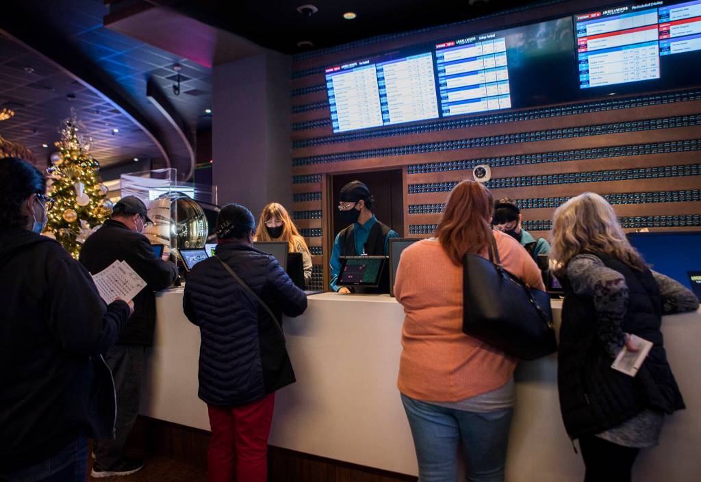 People line up to place sports bets at Angel of the Winds Casino near Arlington. (Olivia Vanni / The Herald)