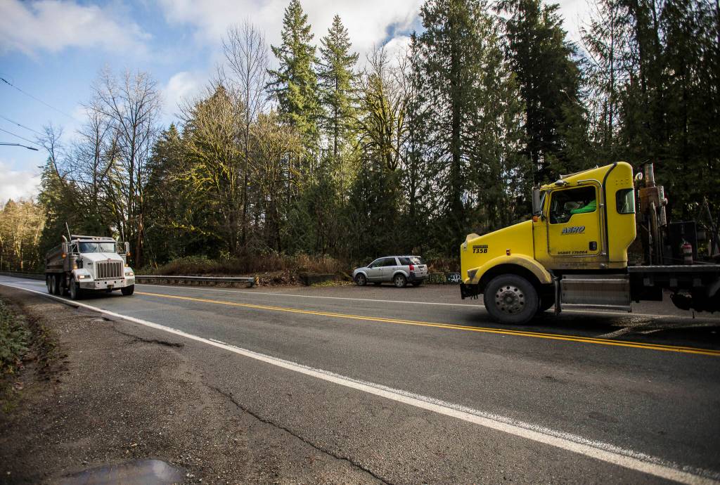 A truck driver waits for another truck to drive across Bridge 102 before crossing Wednesday in Granite Falls. (Olivia Vanni / The Herald)