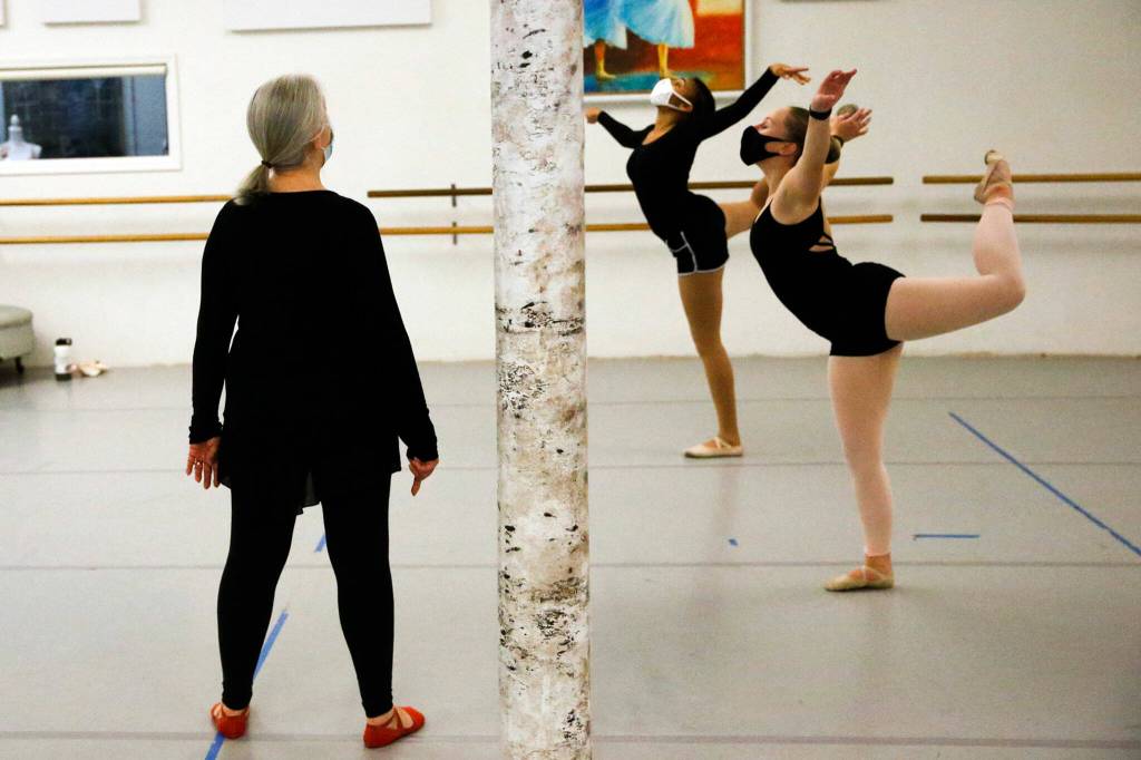 Jennifer Carroll (left) watch dancers Anaya Lorio (center) and Lexi Grove practice Thursday night at the The Dance School in Everett. (Kevin Clark / The Herald)