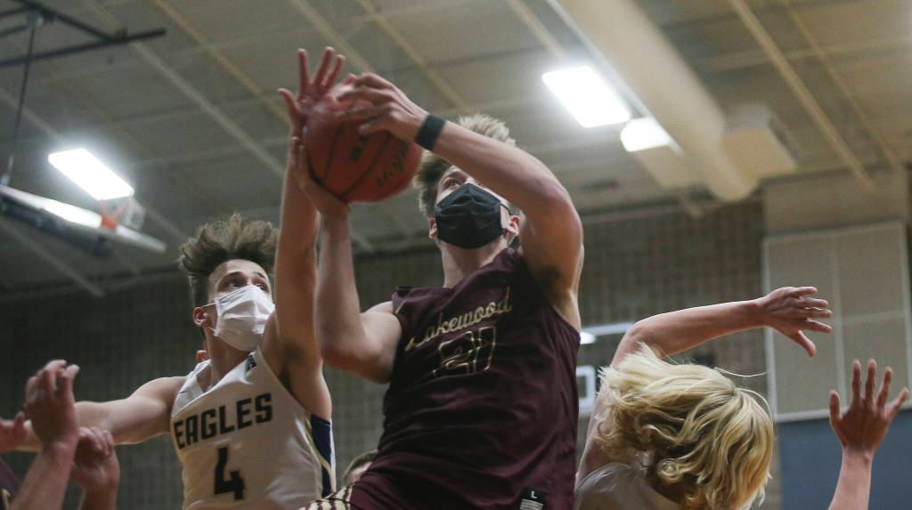 Lakewoods Blake Conyers tries for a basket under heavy pressure during a game on Wednesday, May 19, 2021 in Arlington, Washington. (Andy Bronson / The Herald)