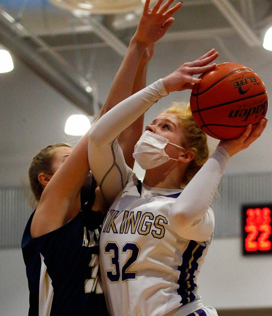 Lake Stevens Cori Wilcox attempts a shot with Arlingtons Ella Stritmatter defending Wednesday evening at Lake Stevens High School on June 9, 2021. (Kevin Clark / The Herald)