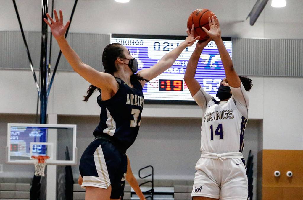 Arlingtons Jenna Villa blocks a shot attempt by Lake Stevens Baylor Thomas Wednesday evening at Lake Stevens High School on June 9, 2021. (Kevin Clark / The Herald)
