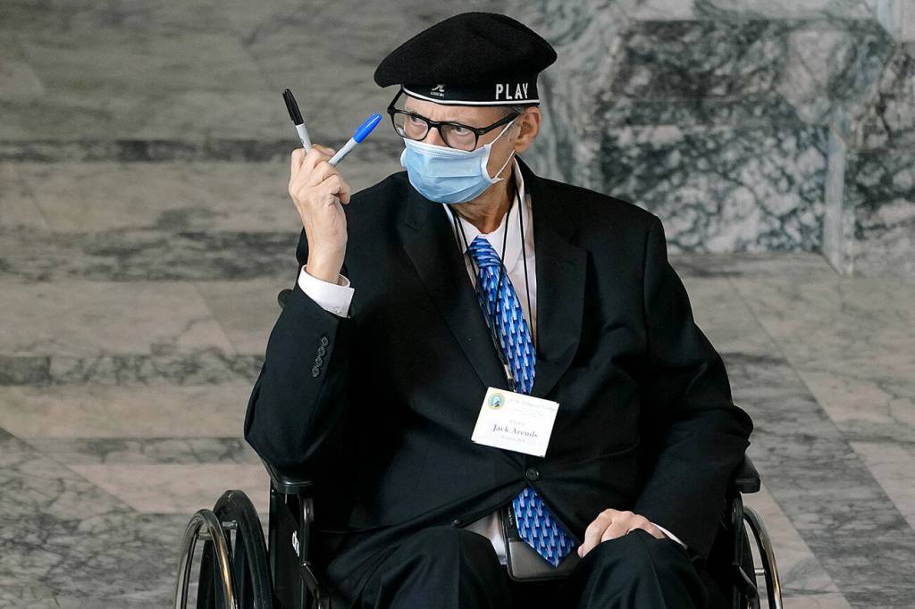 Jack Arends, a member of Washingtons Electoral College, holds up the markers he used to cast his votes for the president and vice president of the United States at the state Capitol in Olympia on Dec. 14, 2020. (AP Photo/Ted S. Warren)