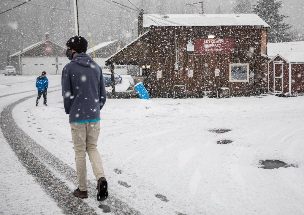 High school students walk through Skykomish, past the library, which is one of two places with public access to internet. (Olivia Vanni / The Herald)