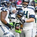 Seattle Seahawks wide receiver Tyler Lockett (16) celebrates with teammates after catching a pall for a two-point conversion against the Houston Texans during the second half of an NFL football game, Sunday, Dec. 12, 2021, in Houston. (AP Photo/Justin Rex )