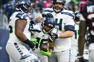 Seattle Seahawks wide receiver Tyler Lockett (16) celebrates with teammates after catching a pall for a two-point conversion against the Houston Texans during the second half of an NFL football game, Sunday, Dec. 12, 2021, in Houston. (AP Photo/Justin Rex )