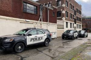 Everett police respond to a situation in an alley between Colby and Rucker on Saturday. The city passed a budget that would provide for eight more police officers to be funded initially by a federal Department of Justice COPS grant. (Sue Misao / The Herald)