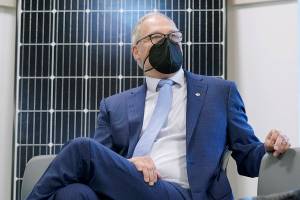 Washington Gov. Jay Inslee sits in front of a solar panel after speaking, Monday, Dec. 13, 2021, at a news conference in Olympia, Wash. Inslee announced several climate-related proposals for the 2022 legislative session, including a plan to offer rebates on the purchase of new and used electric vehicles for qualified buyers. (AP Photo/Ted S. Warren)