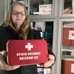 Debra Cross, director of operations for Provoking Hope, an addiction recovery center in McMinnville, Oregon, displays an emergency kit used to treat opioid overdose as she stands inside an ambulance converted into a mobile needle-exchange unit. (AP Photo/Andrew Selsky)
