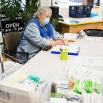 Grama Patty gets someone set up to do their laundry during North Snohomish County Outreach's Laundry Outreach on Wednesday, Dec. 1, 2021 in Arlington, Wa. (Olivia Vanni / The Herald)