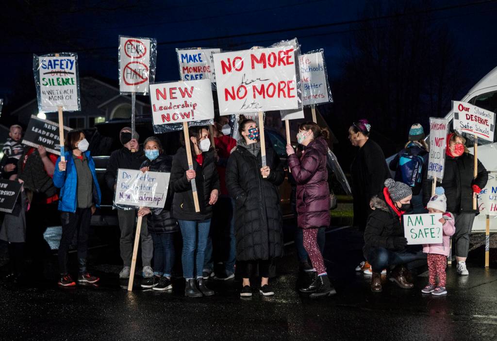 Teachers, parents and students gather on Monday in front of the Monroe School District building for a rally demanding the district address harassment and bullying problems. (Olivia Vanni / The Herald)