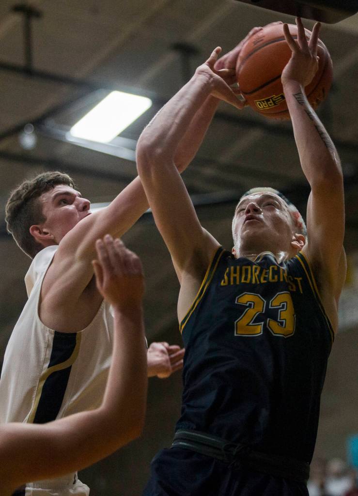 Shorecrests Parker Baumann has his shot blocked during the game against Arlington on Tuesday, Dec. 14, 2021 in Arlington, Wa. (Olivia Vanni / The Herald)