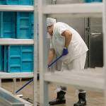 FILE - In this file photo taken Sept. 10, 2019, workers are shown in the kitchen of the U.S. Immigration and Customs Enforcement (ICE) detention facility in Tacoma, Wash. during a media tour. Washington state's effort to force a privately run immigration jail to pay its detainees minimum wage for work they perform can continue, after all. U.S. District Judge Robert Bryan in Tacoma said last month that he intended to dismiss the case, and he invited state Attorney General Bob Ferguson and lawyers for the GEO Group, which runs the detention center, to comment on a proposed order he planned to file. (AP Photo/Ted S. Warren,File)