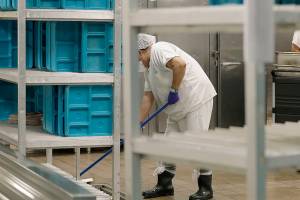 FILE - In this file photo taken Sept. 10, 2019, workers are shown in the kitchen of the U.S. Immigration and Customs Enforcement (ICE) detention facility in Tacoma, Wash. during a media tour. Washington state's effort to force a privately run immigration jail to pay its detainees minimum wage for work they perform can continue, after all. U.S. District Judge Robert Bryan in Tacoma said last month that he intended to dismiss the case, and he invited state Attorney General Bob Ferguson and lawyers for the GEO Group, which runs the detention center, to comment on a proposed order he planned to file. (AP Photo/Ted S. Warren,File)