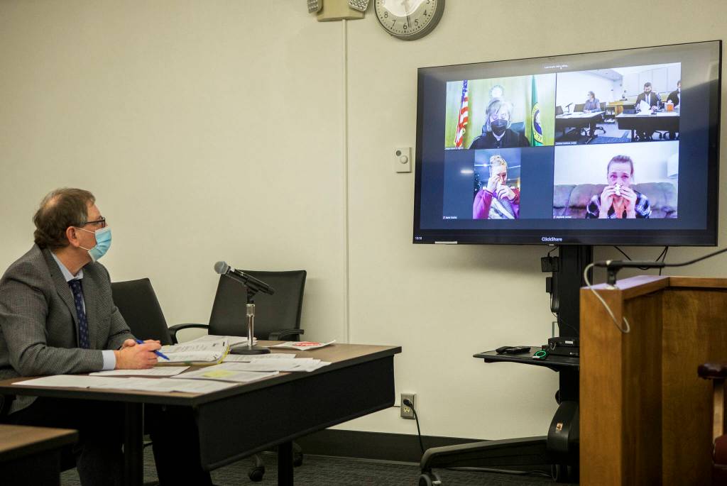 Family members and friends of Brandon Elias react during a videoconference while listening to victim impact statements during Aaron Blanchards sentencing on Wednesday in Everett. (Olivia Vanni / The Herald)