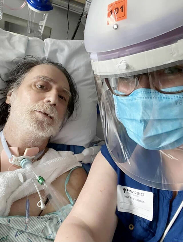 Gunard Hulskamp and his stepdaughter, Heather Columbus (wearing a face shield), while he was hospitalized for COVID-19. (Submitted photo)