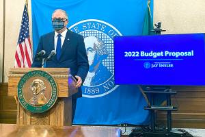 Washington Gov. Jay Inslee, announces a supplemental budget that increases spending on homelessness effort and climate proposals, in Olympia, Wash., on Thursday, Dec. 16,2021. The 60-day legislative session begins Jan. 10, and Democratic leaders in the House will release their own proposals. (AP Photo/Rachel La Corte)